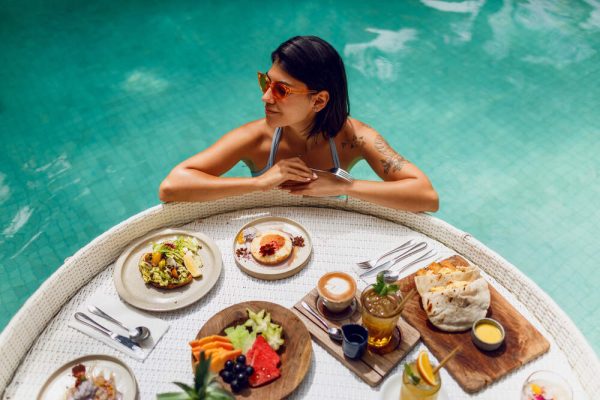 Young-sexy-woman-having-breakfast-in-a-private-pool.jpg