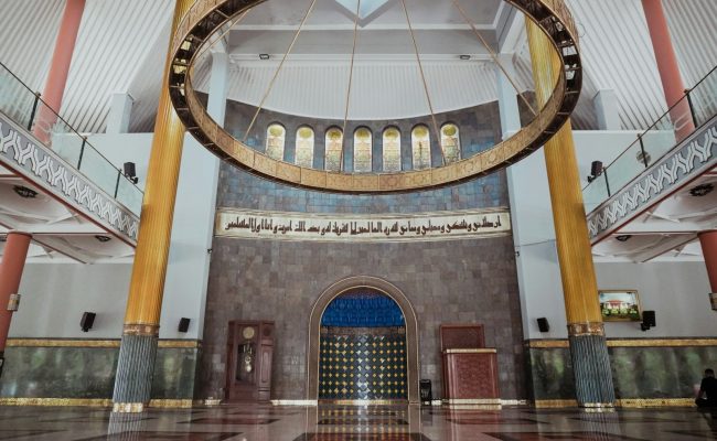 Interior of a grand mosque with large chandelier